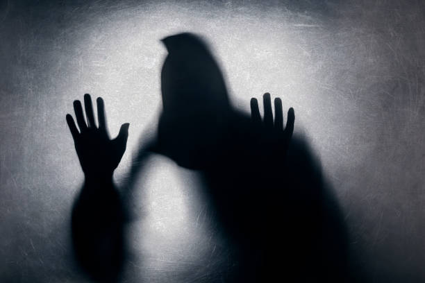 istock Ghostly figure behind a dusty scratched glass 1138557908