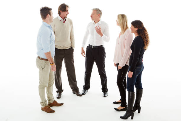 High angle shot of a group of businesspeople huddled together in solidarity in a modern office