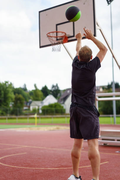 istock Man practicing his basketball aiming for a goal 1138559700