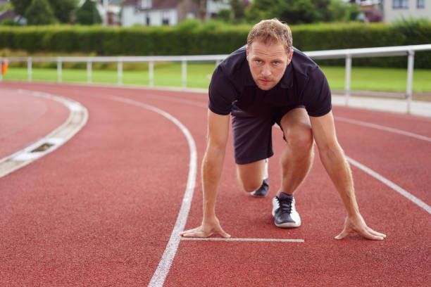 istock Runner ready on the starting grid on a race track 1138559925
