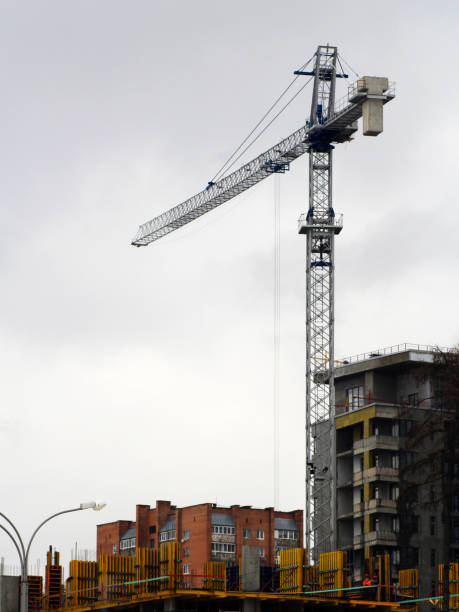 istock Crane and building construction site against sky 1138560120
