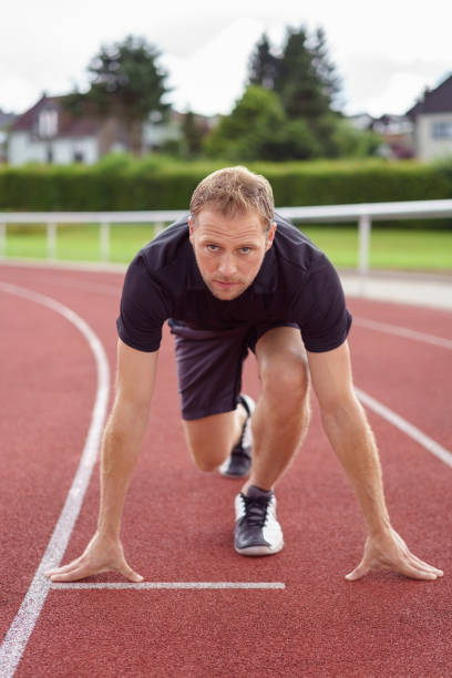 istock Muscular male athlete in the starter position 1138560385