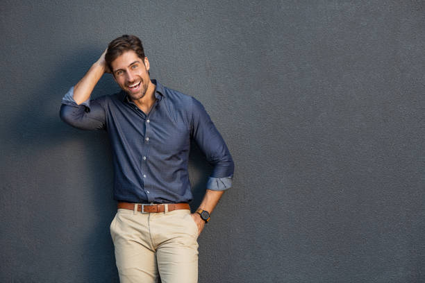 cheerful young man laughing - hand in hair imagens e fotografias de stock