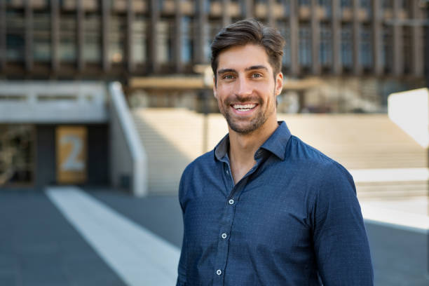 Portrait of casual smiling man Portrait of happy young man in casual clothing looking at camera outdoor. Smiling man with beard feeling confident. Successful business man in city street. 30 34 years stock pictures, royalty-free photos & images