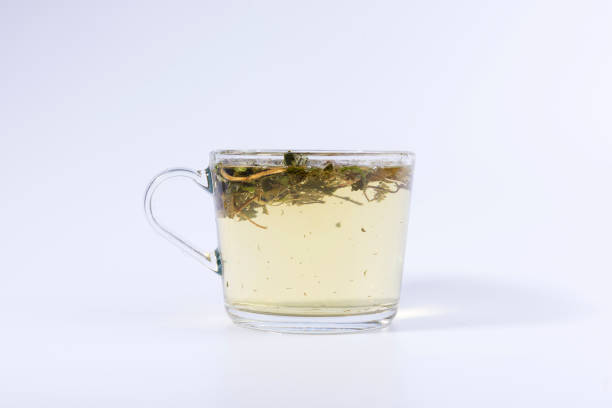 istock green herbal tea in a transparent cup isolated on white background 1138563108