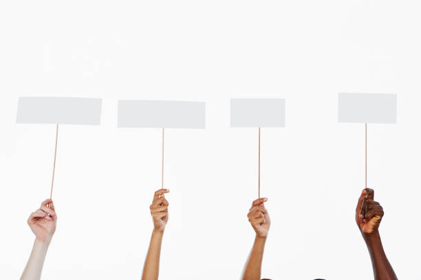istock Four hands hold up blank signs ready for your message 1138564061