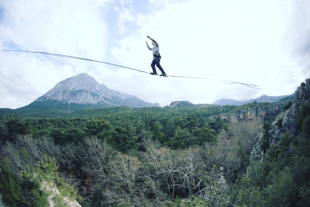 istock Man balancing on the rope concept of risk taking and challenge. 1138564169