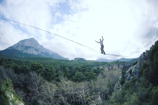 istock Man balancing on the rope concept of risk taking and challenge. 1138564171