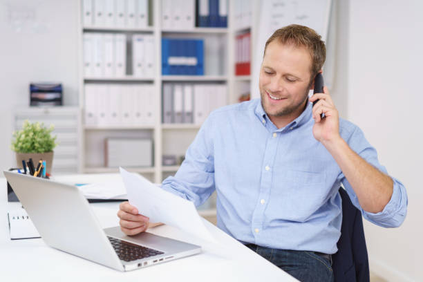Happy businessman chatting on the phone stock photo