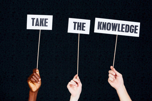 istock Three hands hold up signs 