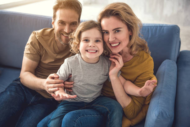 istock Joyful parents are having fun with son 1138568092