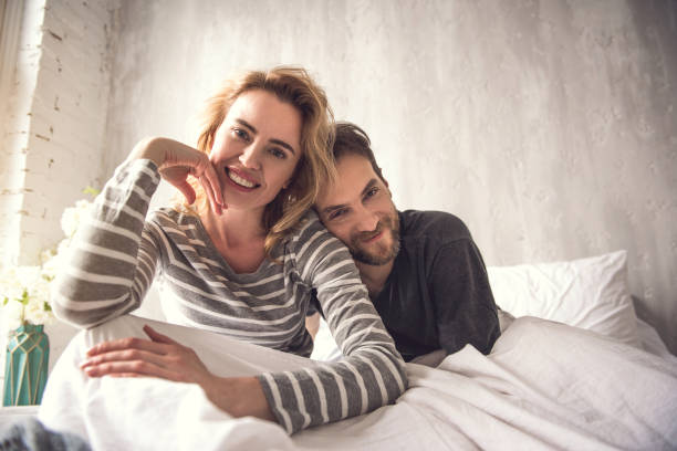 istock Loving couple is cuddling in bed 1138568123