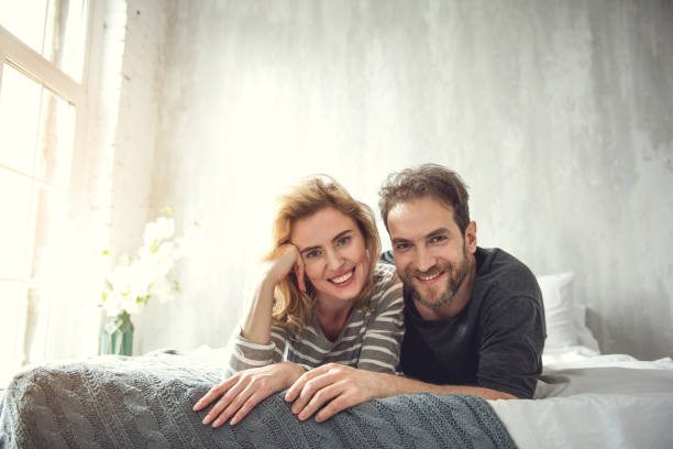 istock Loving couple is relaxing in bedroom 1138568157