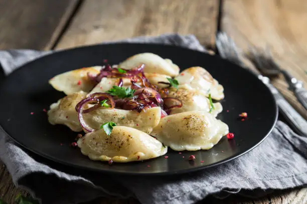 Dumplings, pelmeni, pierogi, with fried onions