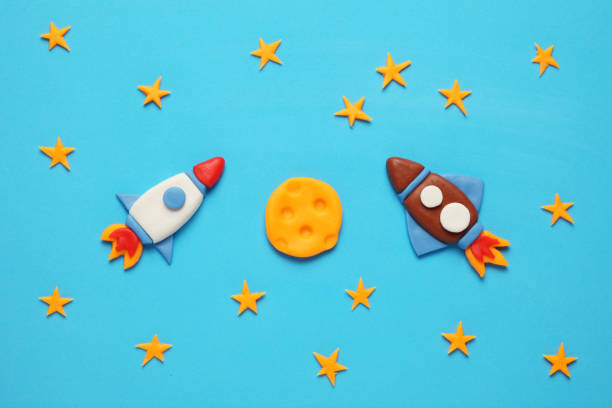 istock Two kid (child) rocket in space, adventure and science. Stars, and moon. Plasticine art, cartoon 1138569749