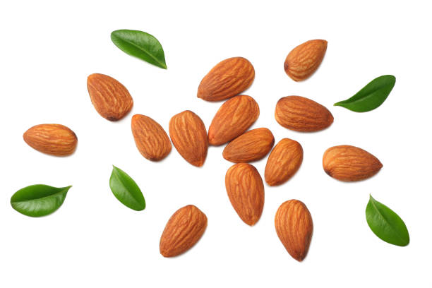 istock almonds with green leaves isolated on white background. top view. 1138571800