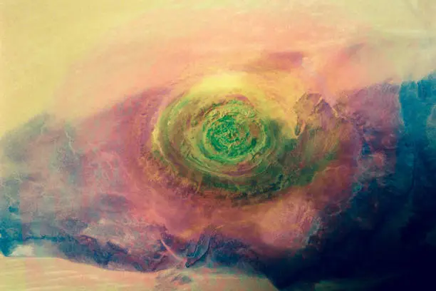Sahara eye. Richat Structure in Western Mauritania. Colorful collage. Elements of this image furnished by NASA.

/urls:
https://images.nasa.gov/details-41c-39-1973.html,
https://images.nasa.gov/details-GSFC_20171208_Archive_e000078.html,
https://earthobservatory.nasa.gov/images/92071/richat-structure /