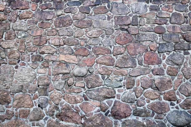 istock wall of granite cobblestones of different sizes 1138575480
