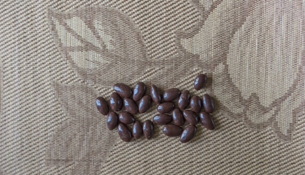 Food image close up candy, chocolate milk, extra dark almond nuts. Texture on top view background