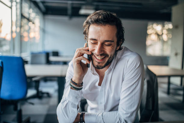 istock Charming businessman talking on mobile in office 1138576111