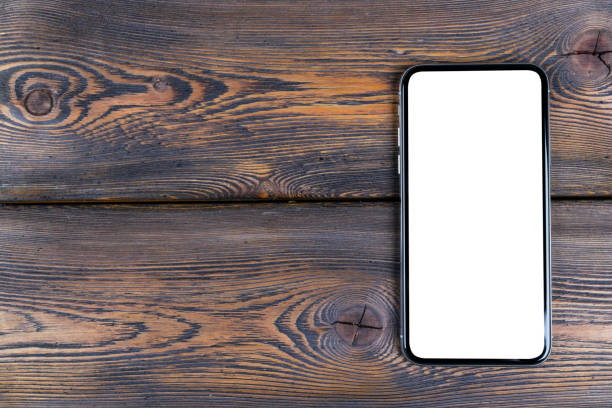 istock Smartphone with blank screen mock up. Smartphone isolated screen. Mobile phone white screen with copy space on computer keyboard. Empty space for text. Isolated white screen 1138579046