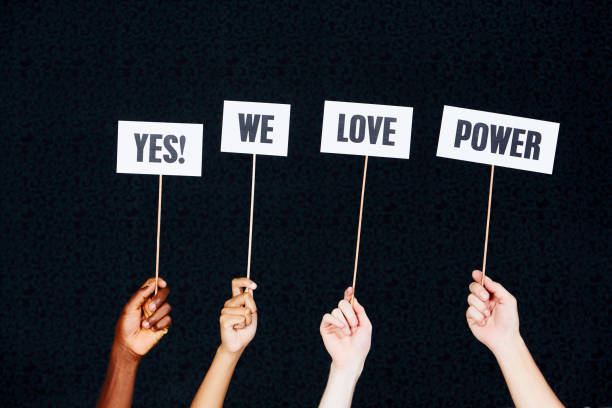 istock Four hands hold up signs 
