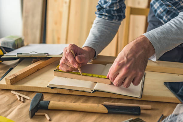 istock Carpenter making wooden picture frame in small business woodwork workshop 1138579723