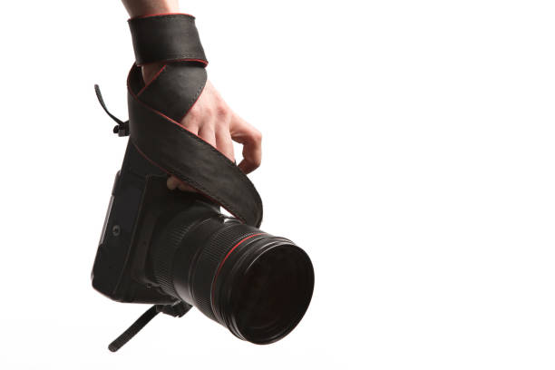 Close up a hand holds dslr photo camera. Isolated on white background