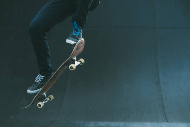 urban skater trick skate ramp man jumping Urban skater in action. Ollie trick. Skate park ramp. City area. Man on skateboard jumping. Copy space for text. longboard skating photos stock pictures, royalty-free photos & images