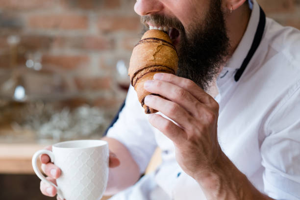 istock snack refreshment delight man hot drink croissant 1138582304