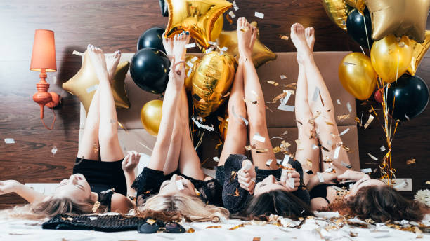istock party women joy fun confetti balloons legs 1138582346