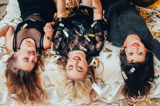 istock women hangout joy lying upside down confetti 1138582350