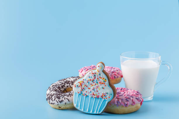 istock Donuts on a blue with a cup of milk 1138582889