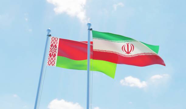 istock Iran and Belarus, two flags waving against blue sky 1138582938