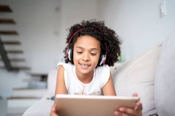 istock Latin girl using digital tablet at home 1138583200