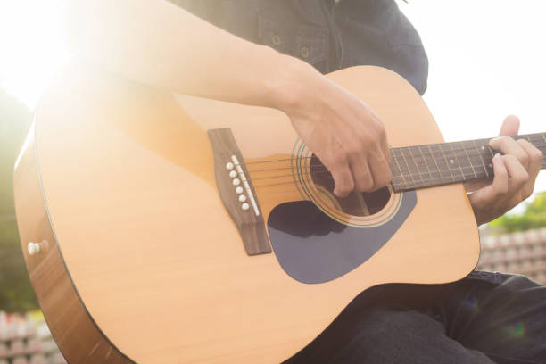 istock Playing on acoustic guitar outdoor 1138589165