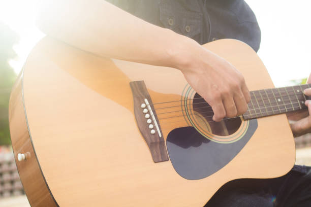 istock Playing on acoustic guitar outdoor 1138589264