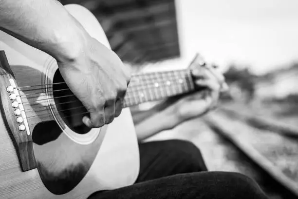 Photo of Playing on acoustic guitar outdoor