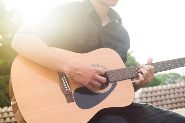 istock Playing on acoustic guitar outdoor 1138589372