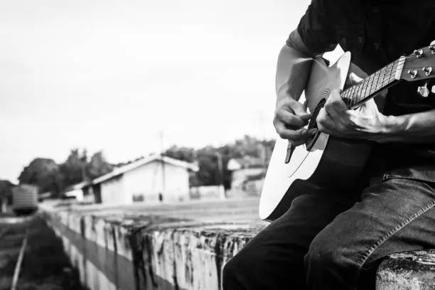 Photo of Playing on acoustic guitar outdoor