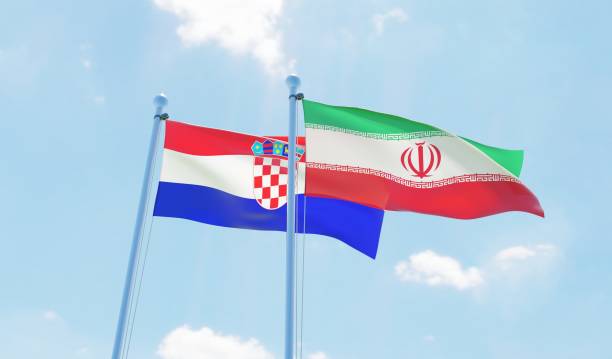 istock Iran and Croatia, two flags waving against blue sky 1138589621