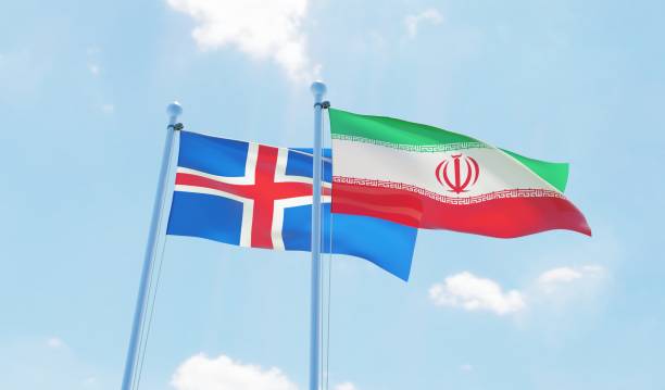 istock Iran and Iceland, two flags waving against blue sky 1138590148