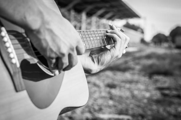 istock Playing on acoustic guitar outdoor. Close-up 1138590178