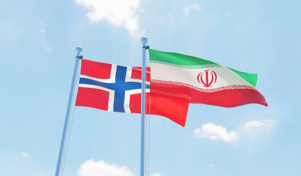 istock Iran and Norway, two flags waving against blue sky 1138590396