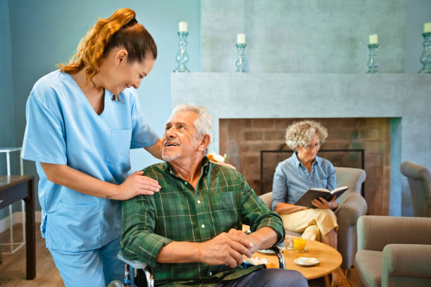 istock Female nurse standing by disabled elderly man 1138592582