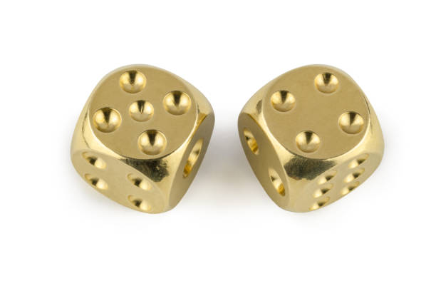 istock Two golden dices closeup isolated on white background. Five and four, with a shadow. 1138592794