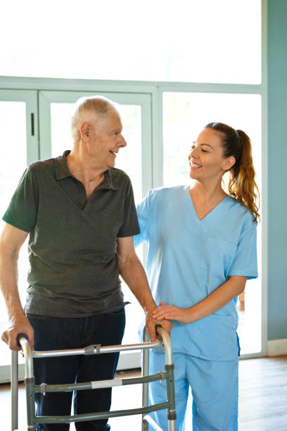 istock Nurse assisting senior man with mobility walker 1138592869