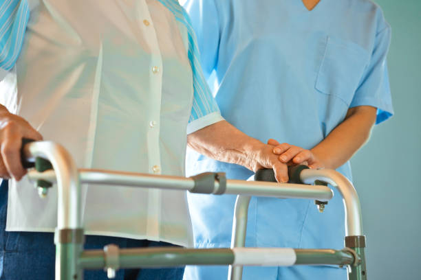 istock Nurse assisting senior woman with mobility walker 1138592912