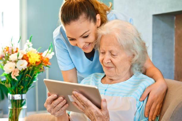 istock Nurse looking at senior woman using digital tablet 1138593736