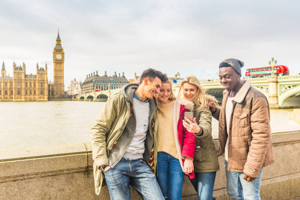 istock Happy multiracial friends group using smartphone in London 1138595575